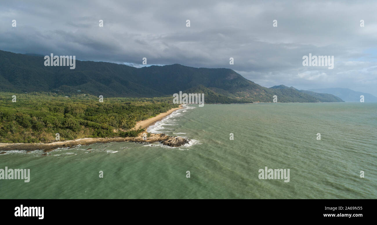 Beautiful tropical landscape with foggy mountains in the background and ocean, beach and headland. Cape tribulation in Australia, Queensland Stock Photo