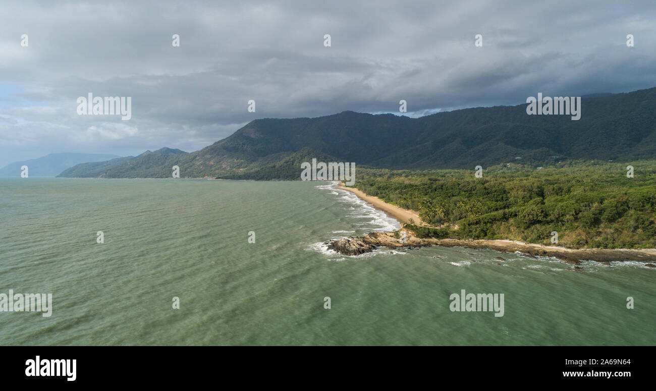 Beautiful tropical landscape with foggy mountains in the background and ocean, beach and headland. Cape tribulation in Australia, Queensland Stock Photo