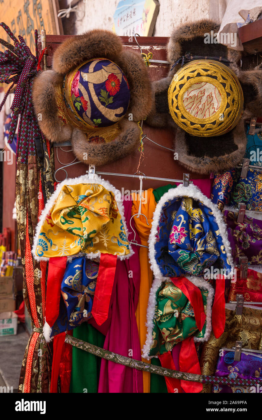Traditional Tibetan hats lined with wool or fur for sale in a street market by Barkhour Square in Lhasa, Tibet, including Golden Thread Hats. Stock Photo