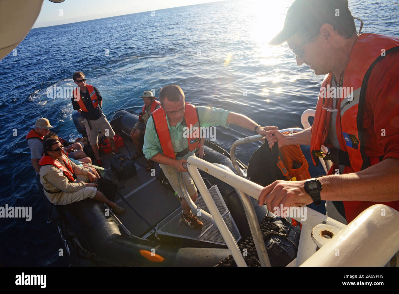 Passengers return to Lindblad Expeditions boat from zodiac tour, Baja California, Mexico Stock Photo