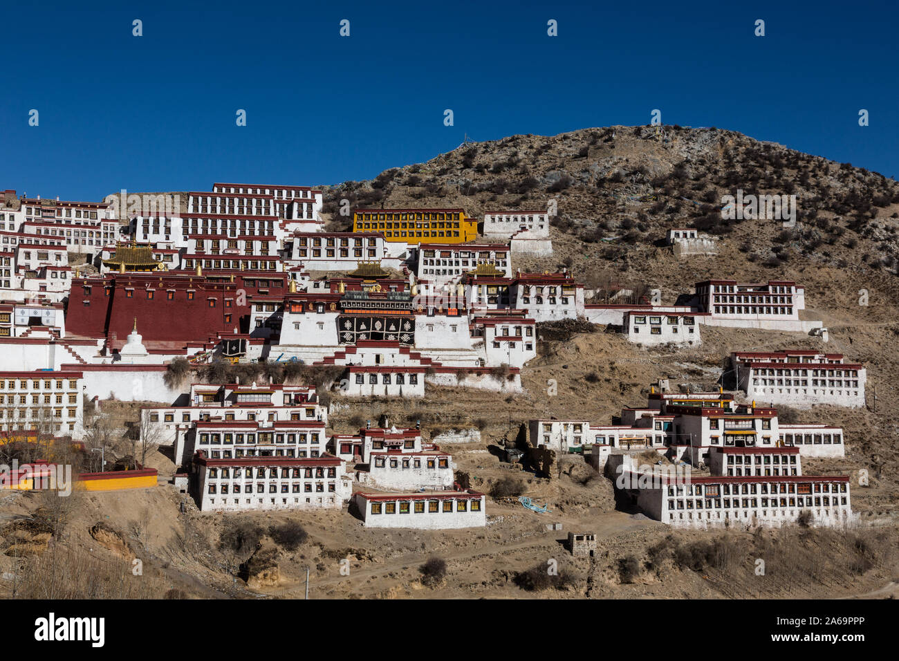 The Serdung Lhakhang is the large red building with the white Tsokchen Hall immediately to its right at the Buddhist Ganden Monastery in Tibet. Stock Photo