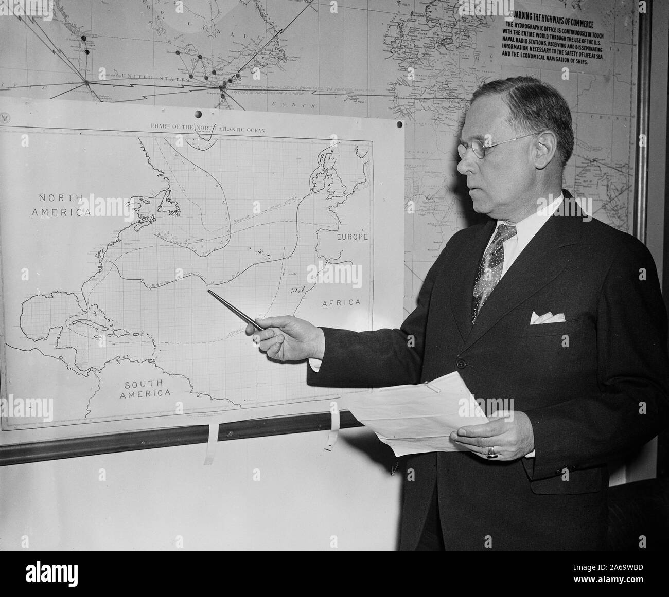 Man with chart showing North Atlantic Ocean ca. 1936 Stock Photo