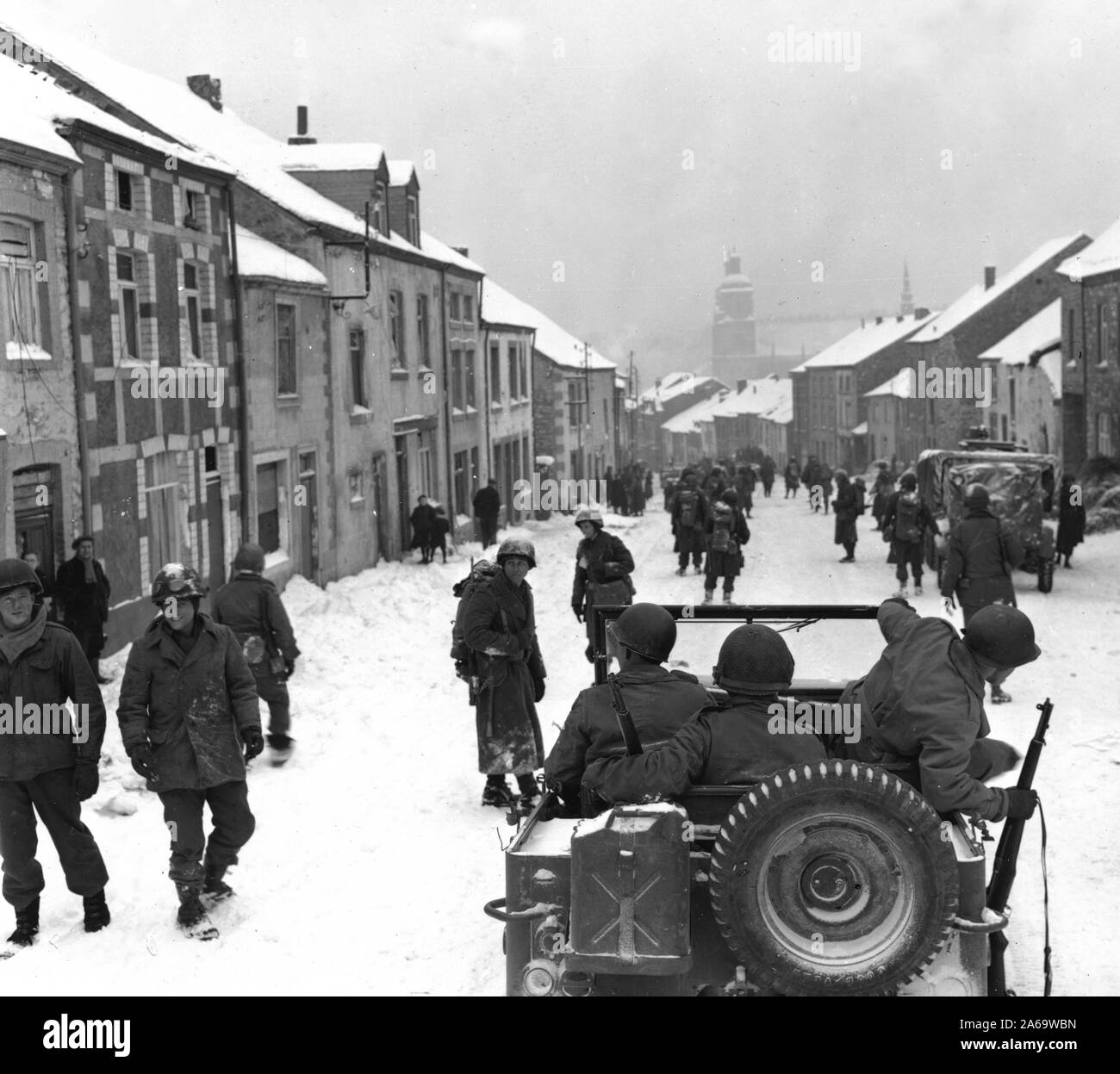 Original caption: St. Hubert, Belgium-American infantryman of the 87th Div. enter the town of St. Hubert right after the Germans fled the town. 1945. Stock Photo