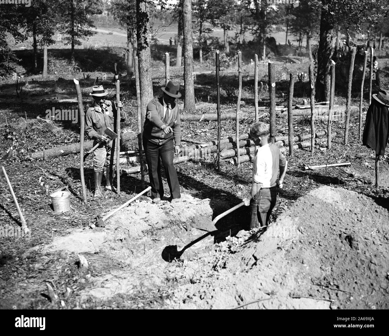'A' boss is shown here instructing a transient worker in ditch digging at 'Tugwelltown,' a.k.a. Greenbelt, Maryland ca. October 1935 Stock Photo