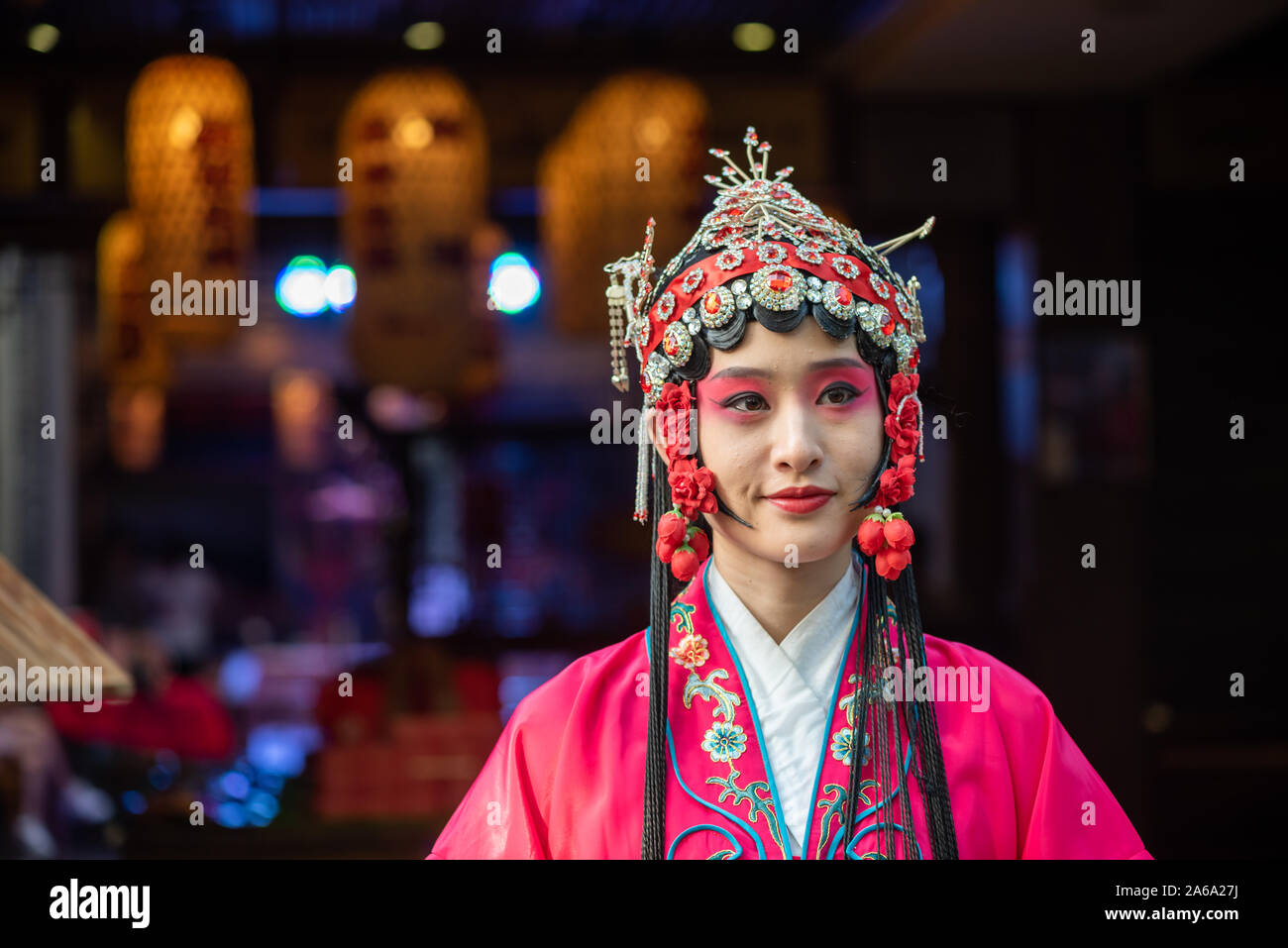 Chengdu, Sichuan Province, China - Oct 11, 2019 : Portrait of a yound woman dressed in Sichuan Opera traditional costume in Jinli street touristic area. Stock Photo