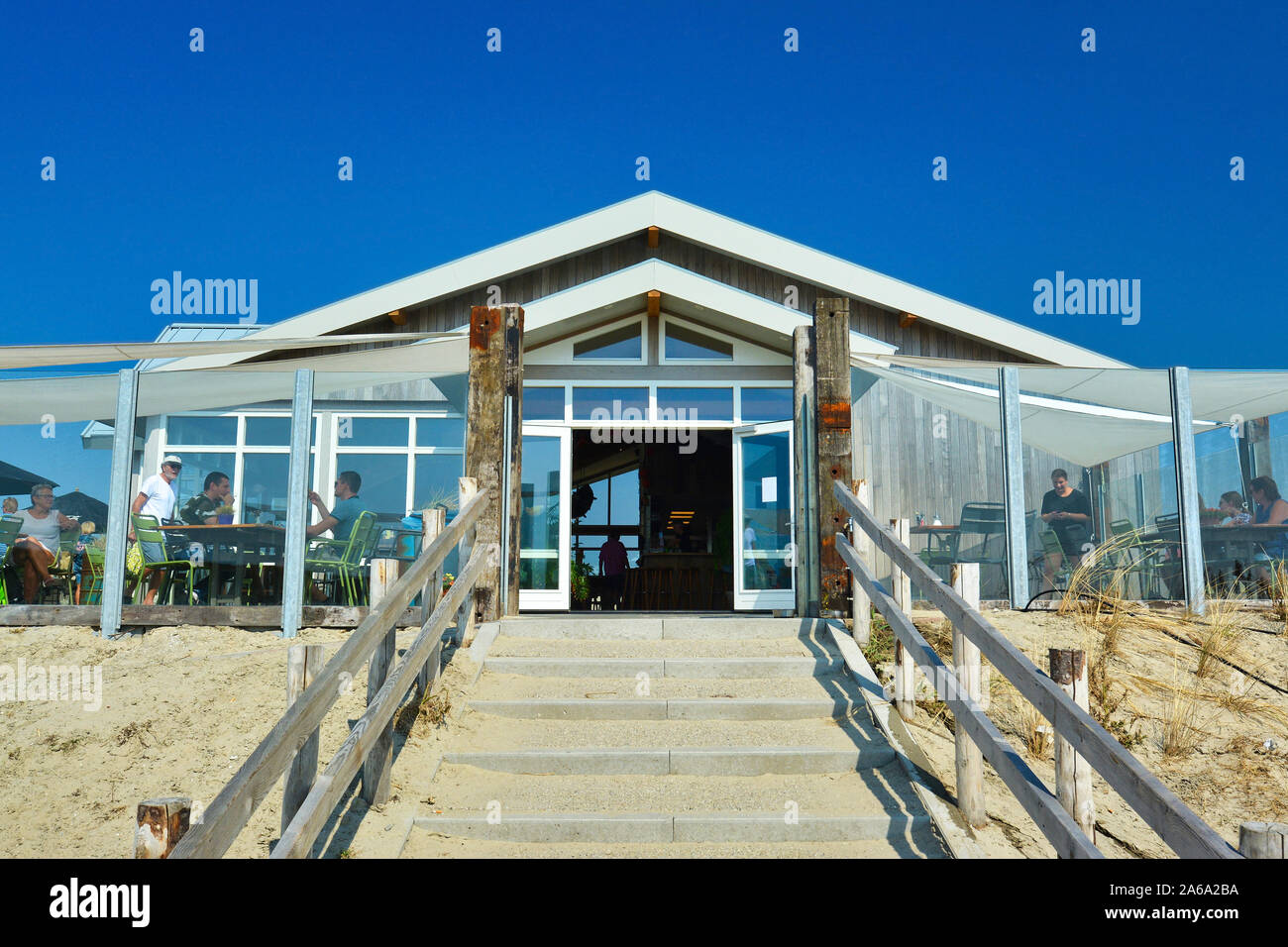 Texel, Netherlands - August 2019: Entrance with stairs to beach pavilion restaurant 'Paal 9' on a sunny day on island Texel Stock Photo