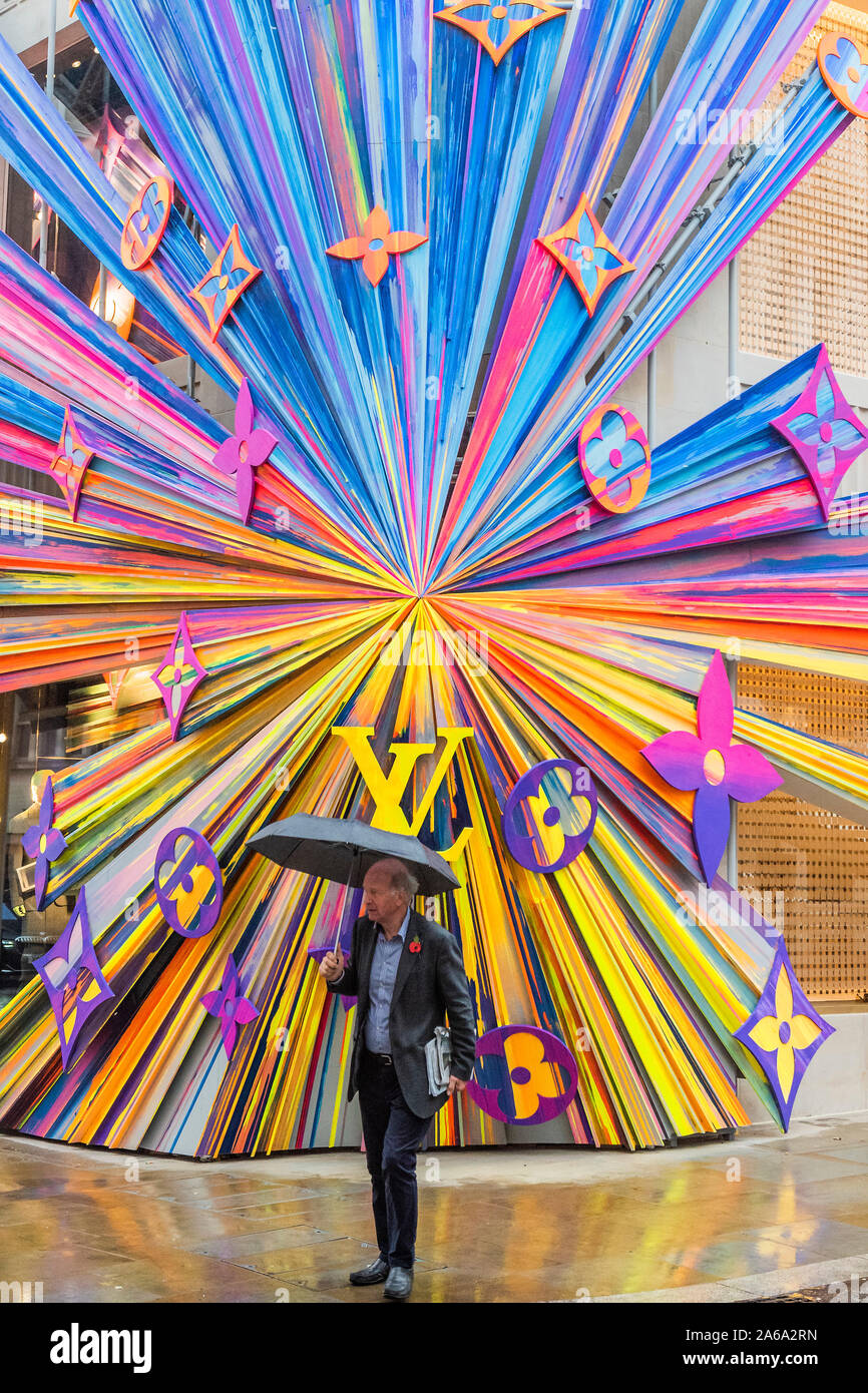 New Bond Street, London, UK. 24th Oct 2019. The refurbished Louis Vuitton store re opens with a huge and colourful explosion of stars installation on its corner outside wall. Credit: Guy Bell/Alamy Live News Stock Photo