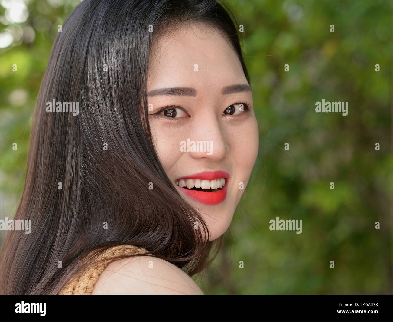 Beautiful, young South Korean smiles for the camera. Stock Photo