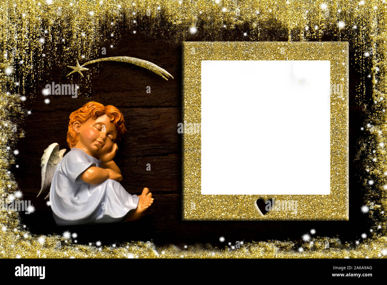 Christmas photo frame card with gold blank picture frame for message or photo.  Sleeping angel and Star of Bethleem on an old wooden background. Stock Photo