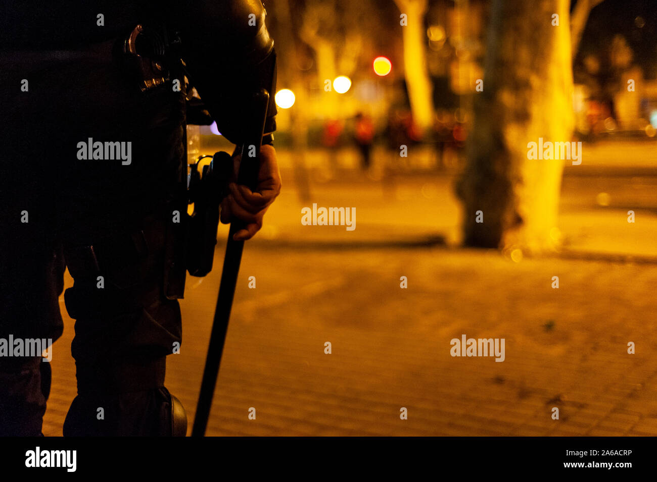 Barcelona, Spain - 18 october 2019: mossos d'esquadra amid fog and smoke catalan police with guns confront with protesters at night during clashes wit Stock Photo