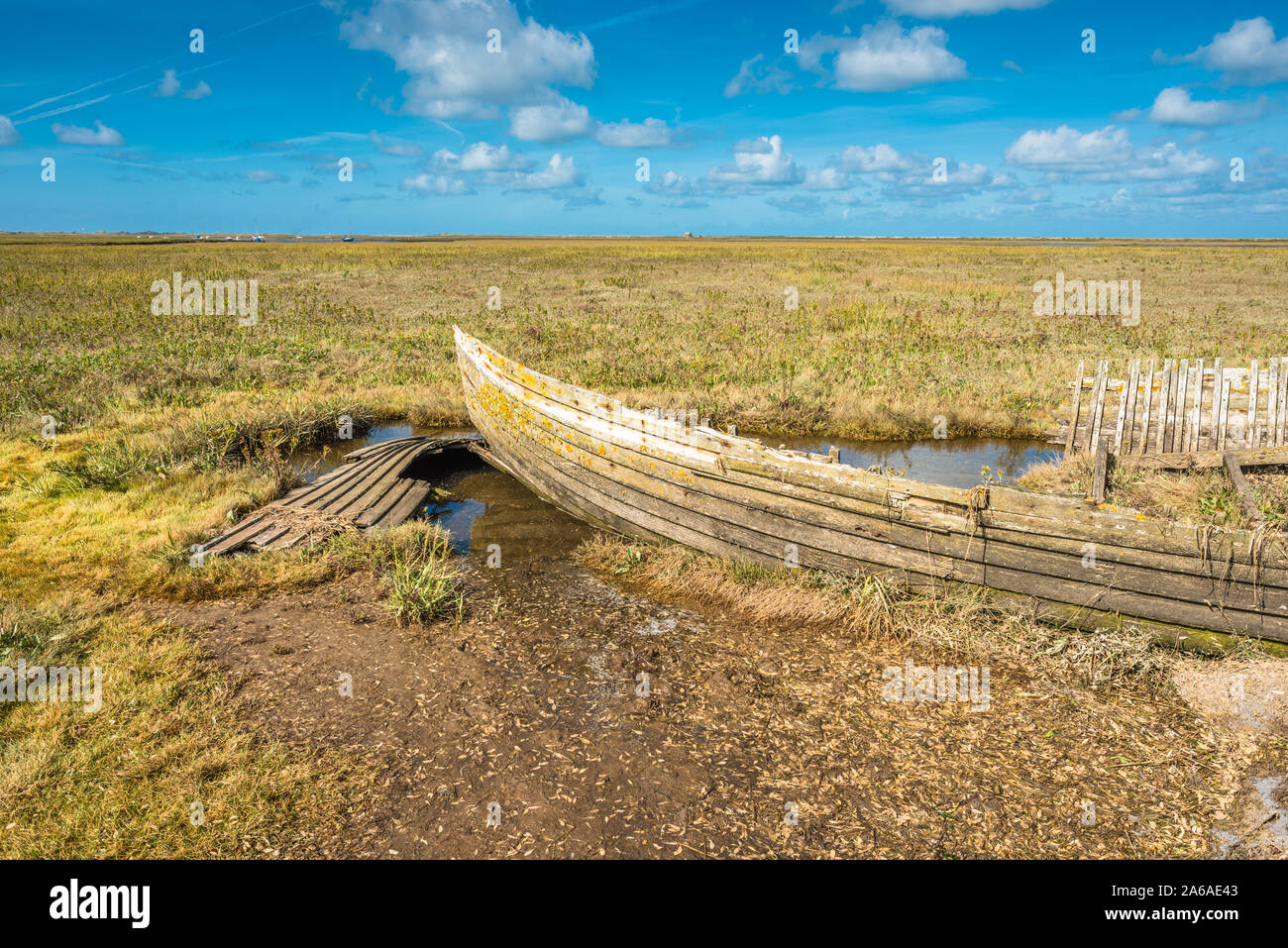 Rustic old boat left to decay on Salt Marshes between Blakeney and Cley next the sea coastal villages on North Norfolk Coast, East of England, UK. Stock Photo