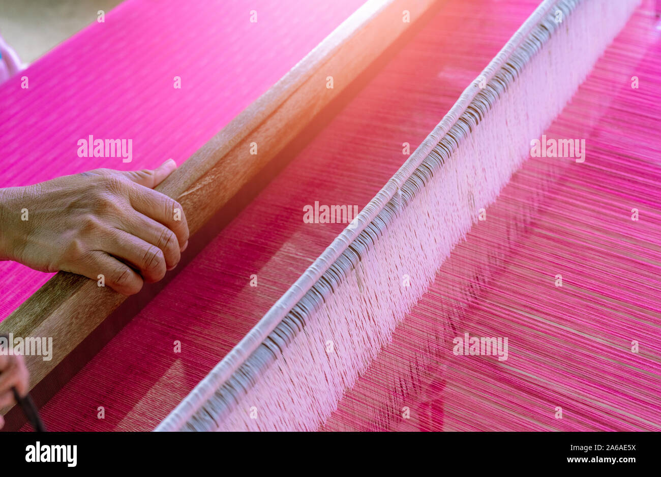 Woman working on weaving machine for weave handmade fabric. Textile