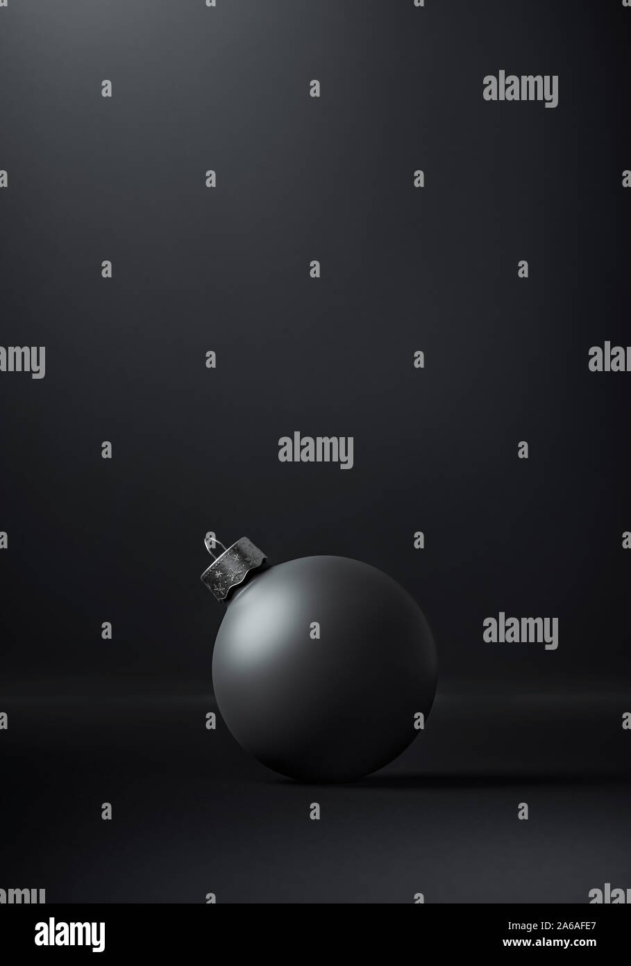 Matte black Christmas bauble centered on a dark grey background for