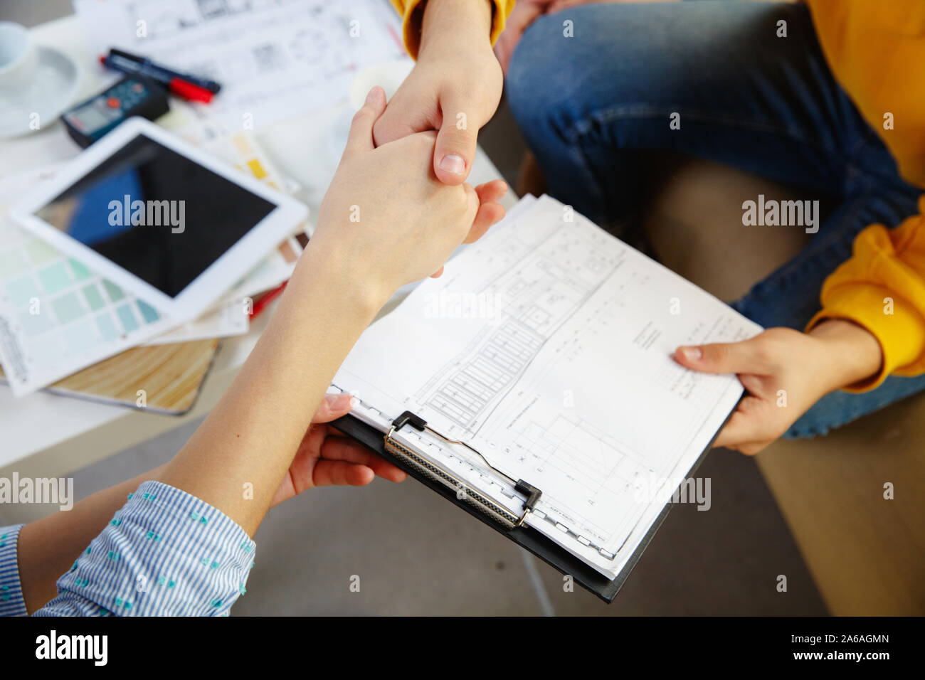 Interior designer working with young couple. Lovely family and ...