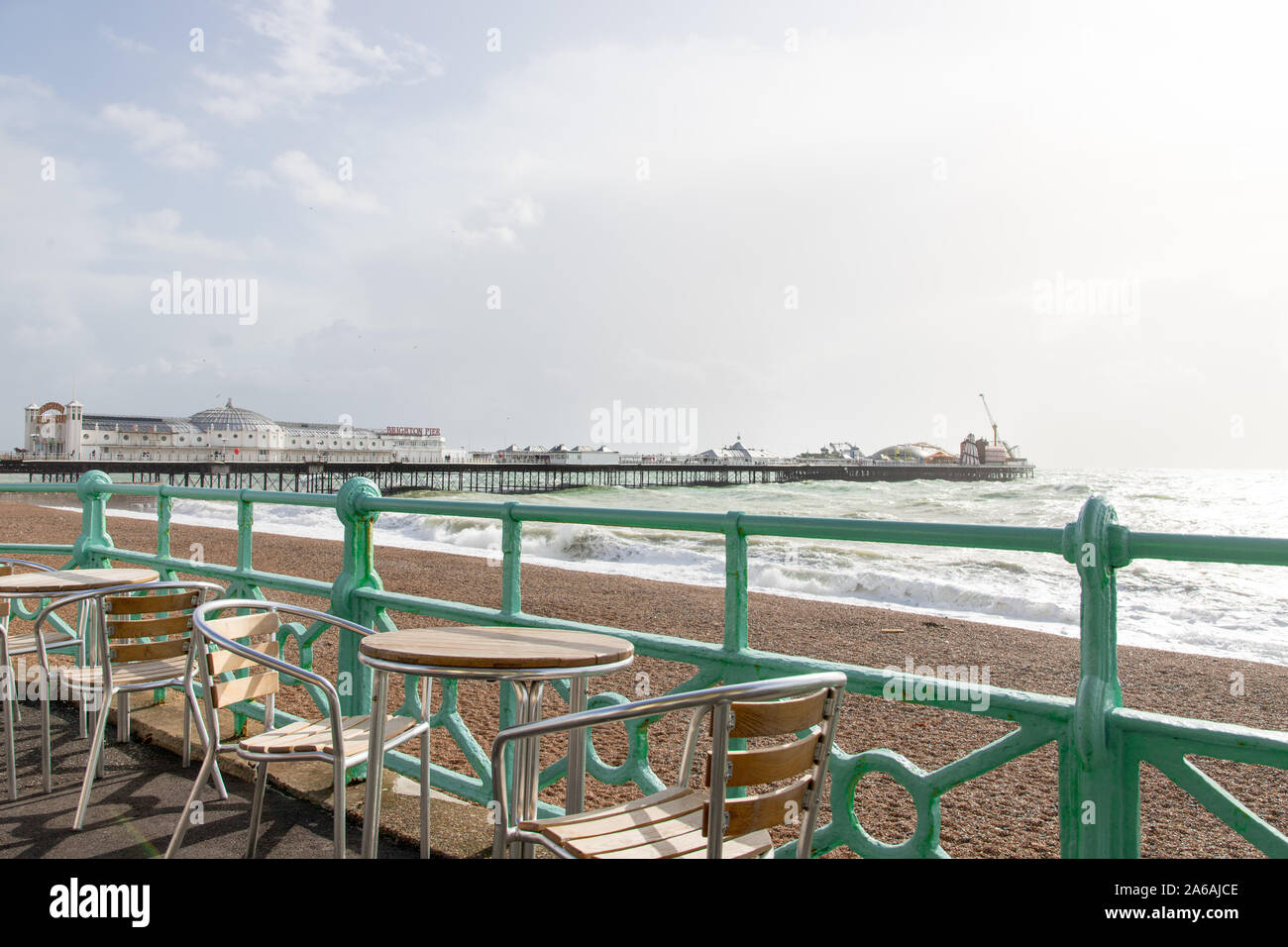View of the Brighton palace pier from a coffee shop terrace with chairs and tables Stock Photo