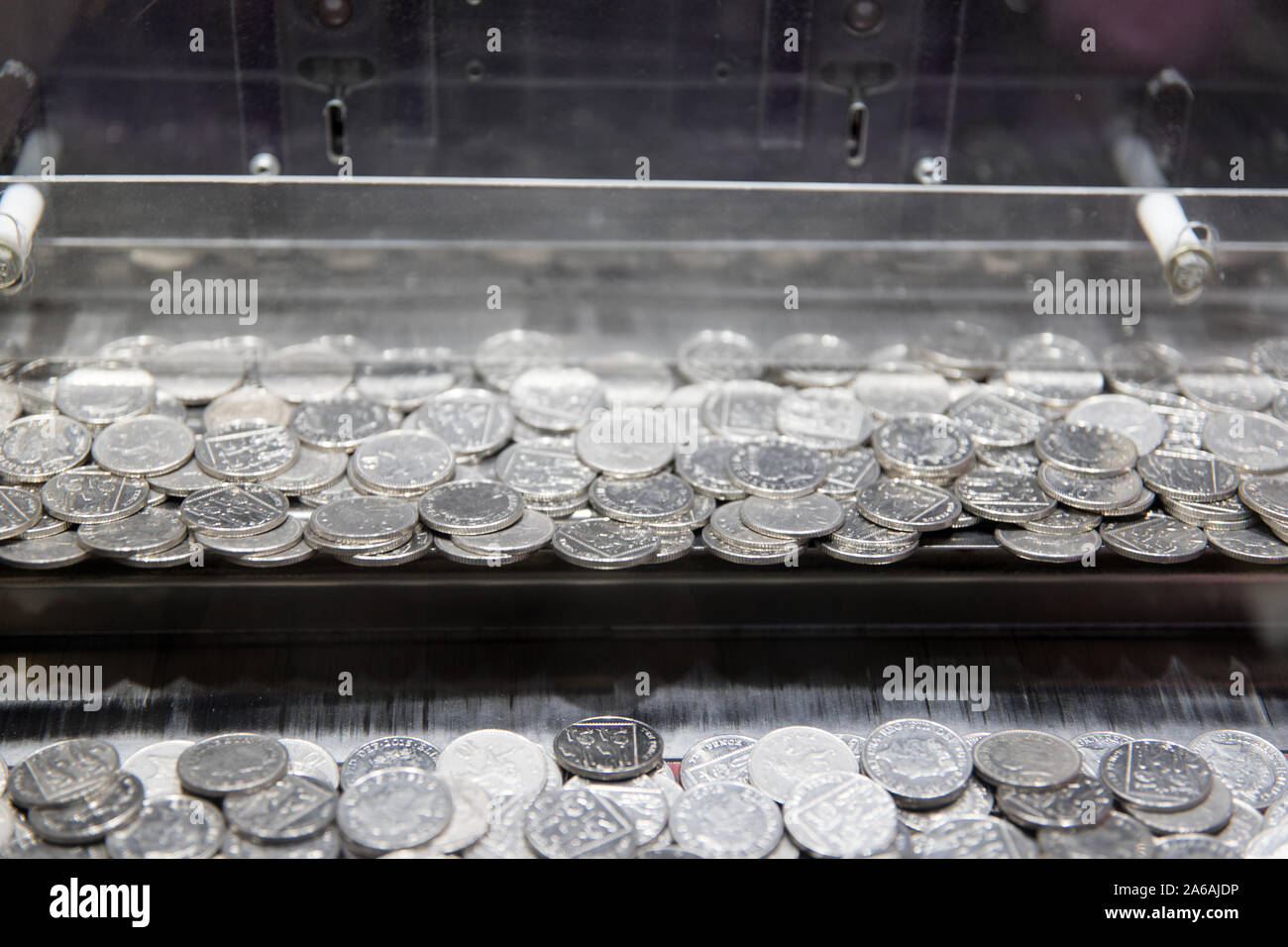 Coin pusher game machine at Brighton palace pier funfair pounds Stock