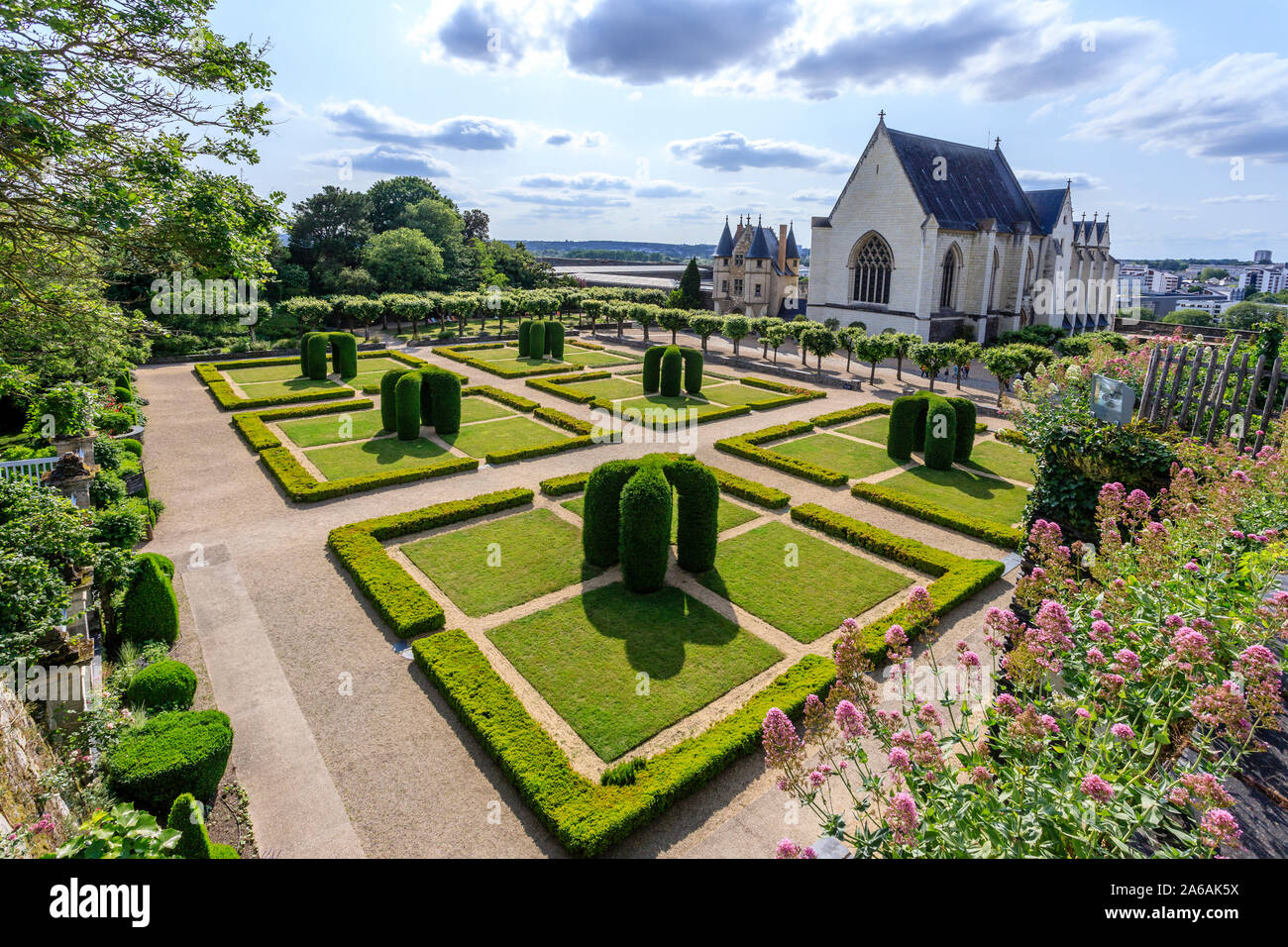 France, Maine et Loire, Angers, Chateau d’Angers, Angers castle, in the main courtyard, the chapel and the Regular garden with arches of carved yews a Stock Photo