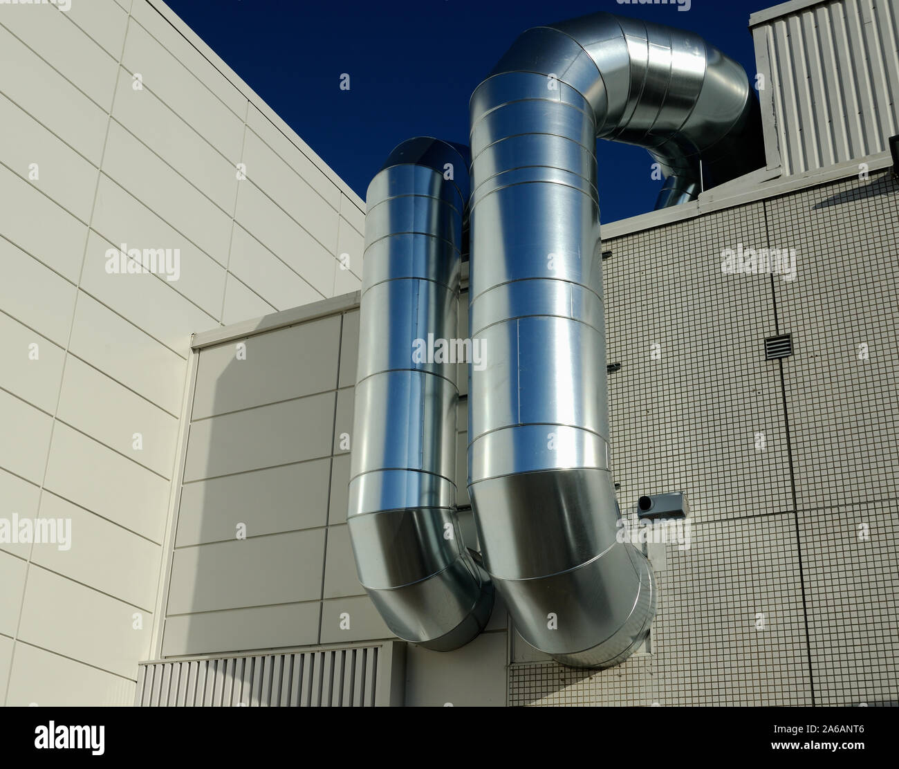 ventilation pipes of industrial building outdoor, against the sky Stock Photo