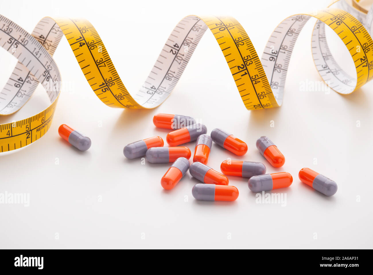 Diet Supplements Pills Capsule With Measuring Tape On White Background Stock Photo Alamy Diet Supplements Pills Capsule With Measuring Tape On White Background Stock Photo Alamy