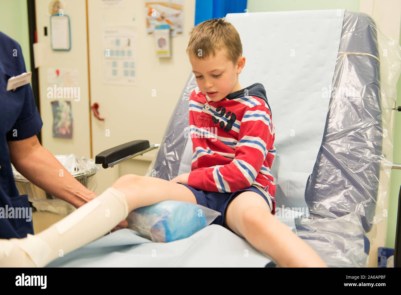 A little boy with ADHD, Autism, Aspergers Syndrome visits the Colchester hospital after breaking his leg playing outdoors at the park, NHS healthcare Stock Photo