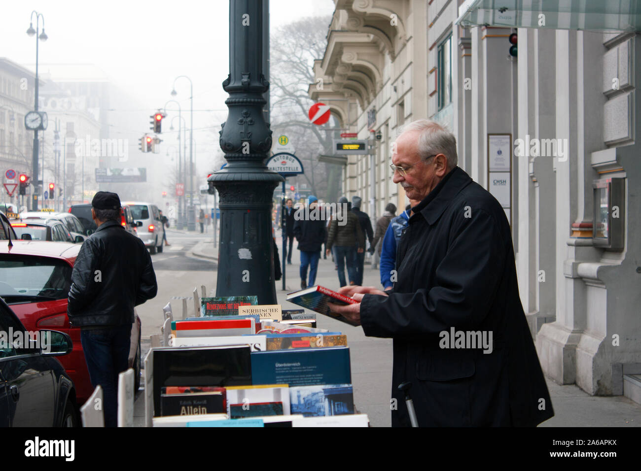 An elderly gentleman browsing books in a street book stand in Vienna, Austria. Stock Photo