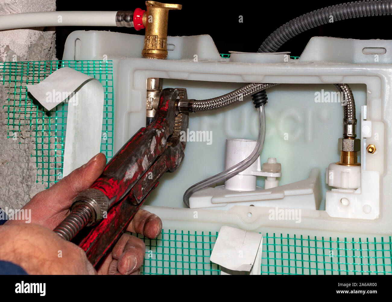 Workers connect the water pipes to the toilet flush box Stock Photo Alamy