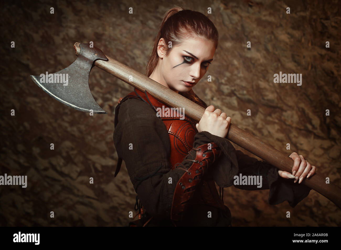 Warrior woman posing with iron axe.Studio shot Stock Photo