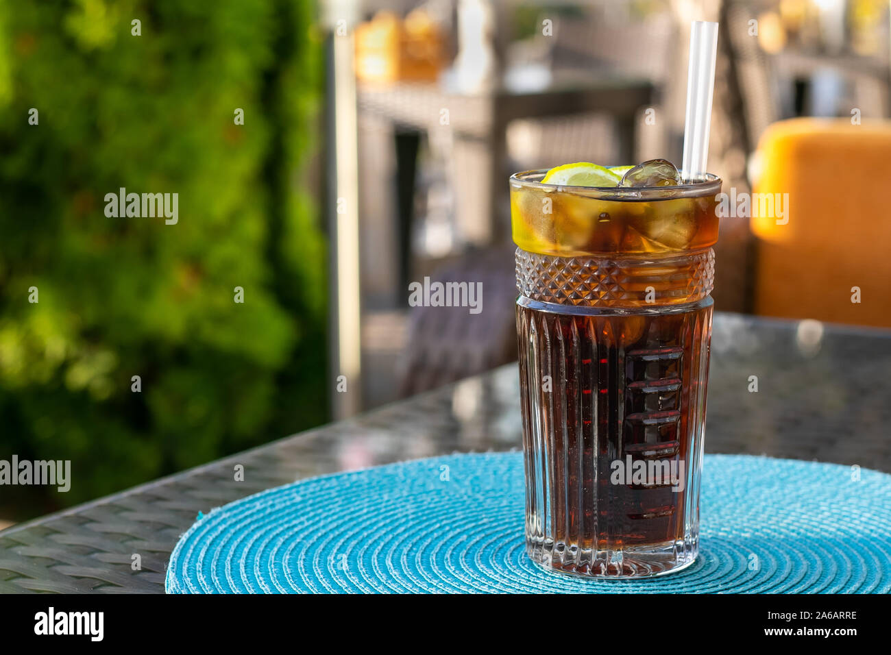 Alcohol cocktail Long Island Iced Tea. Iced tea with lemon in a glass