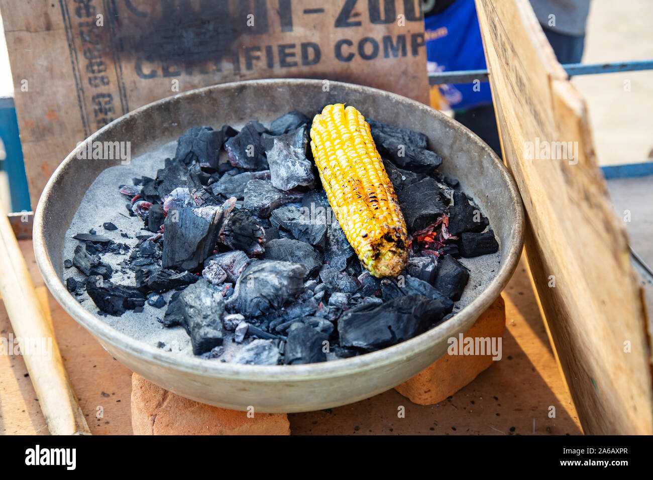 Yellow corn roasted on fire in black carbons Stock Photo Alamy