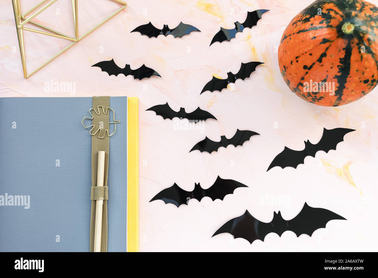 Notebook, pen, pumpkin and bats on a pink background. Halloween concept,  flat lay, top view, social media hero header template, copy space Stock  Photo - Alamy