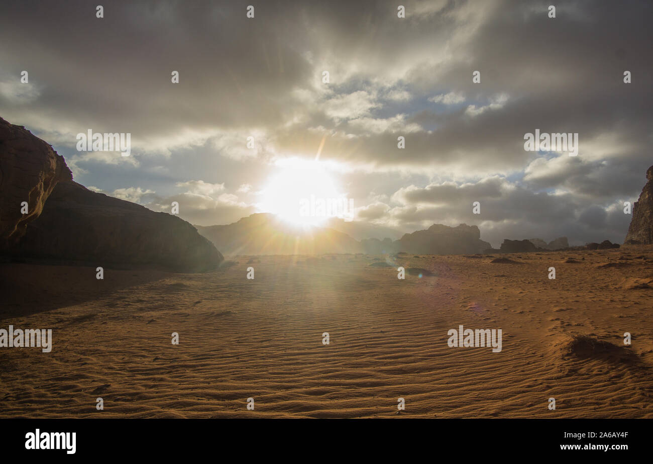 Amazing sunset at the Jordanian desert of Wadi Rum ,this breathtaking sunset will really blow your mind. Its stunning to see how the sun disappearing Stock Photo