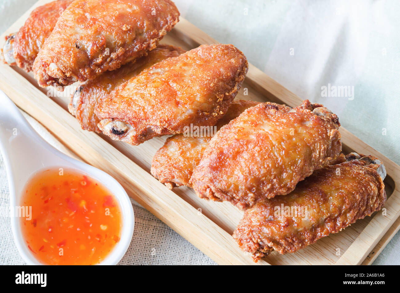 Fried chicken wing with chilli sauce on wooden table Stock Photo Alamy