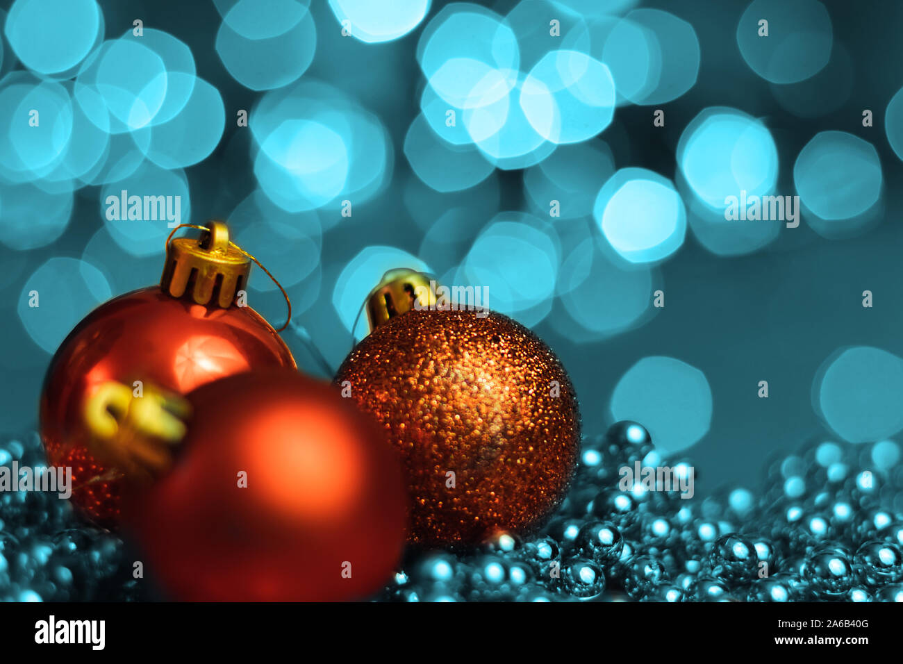 Christmas ornaments lying on balls of a Christmas chain on a blurred background with lights. Stock Photo