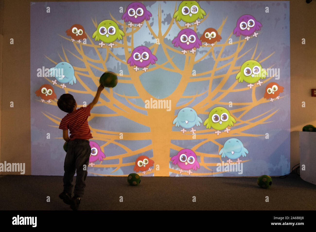 BRATISLAVA, SLOVAKIA - OCT 25, 2019: Kids playing interactive game projected to the wall at the mall in Bratislava, Slovakia Stock Photo