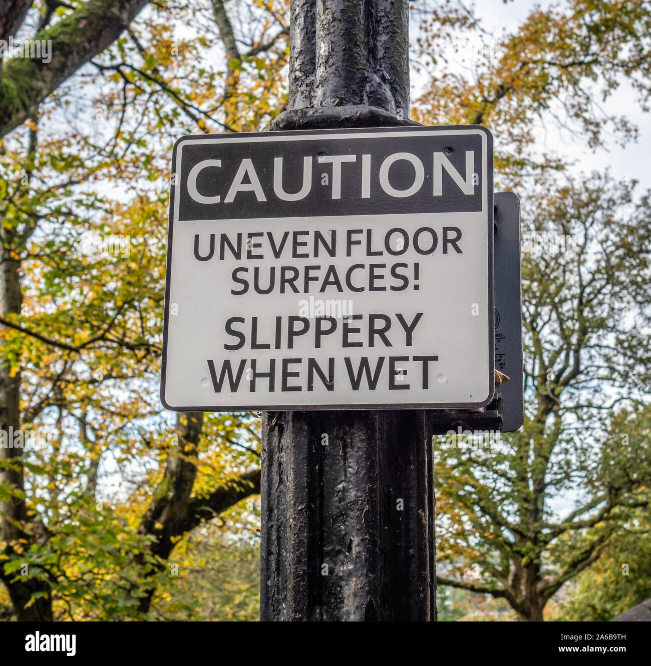 Caution, Uneven Floor Surfaces, Slippery When Wet sign in Lancaster, Lancashire, England, UK. Stock Photo