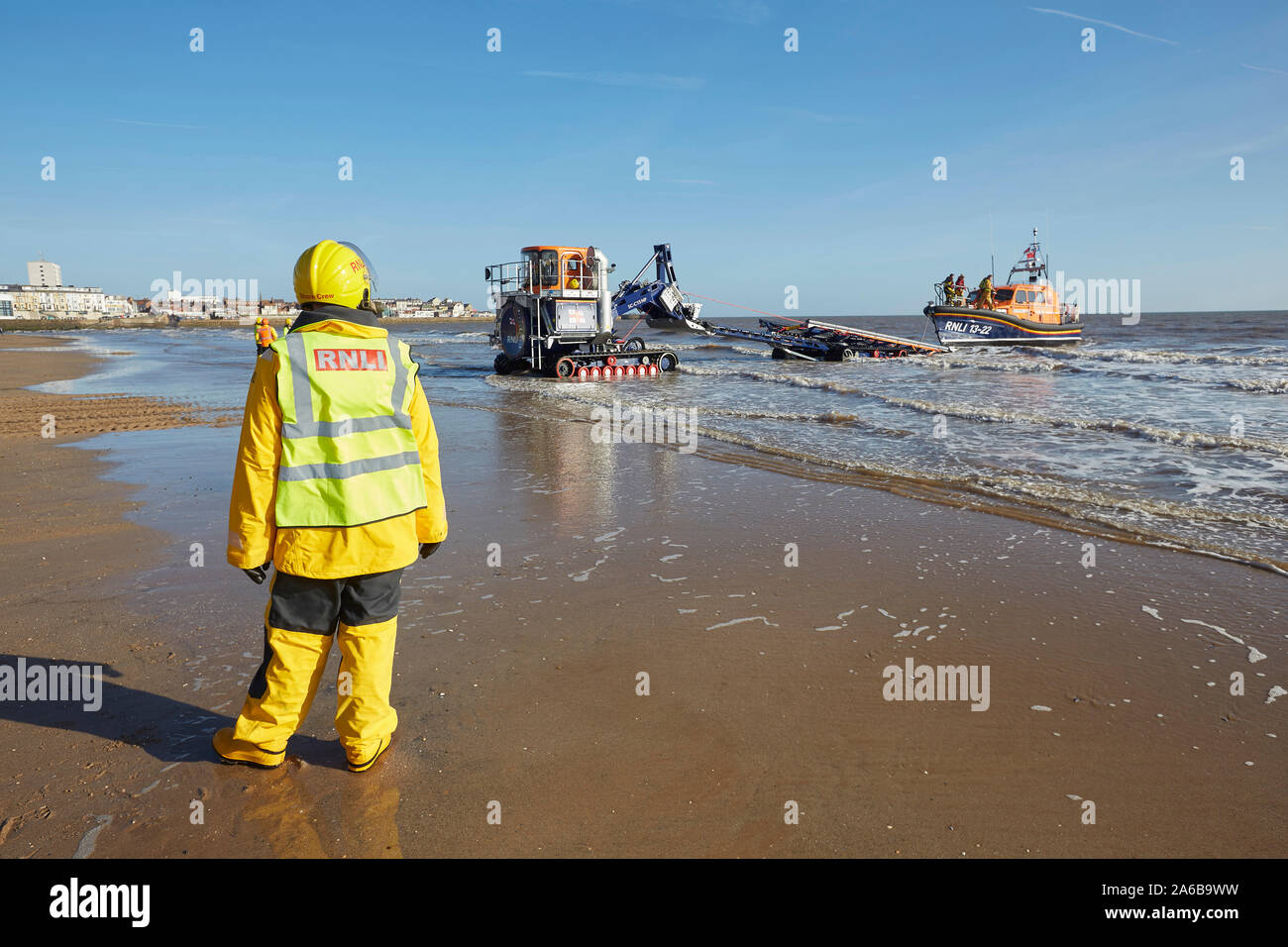 RNLI lifeboat 13-22 launching on Bridlington's south beach, East Yorkshire, UK, with the help of volunteer marine engineers. Stock Photo