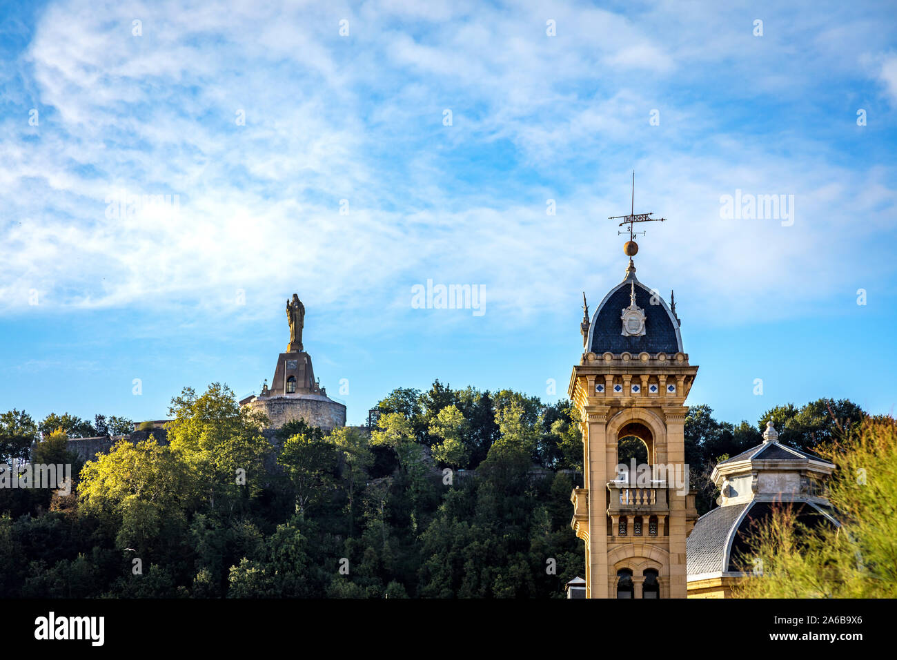 San Sebastián, Spain - 07 September 2019 - View of the statue of the Sacred Heart and a church steeple Stock Photo