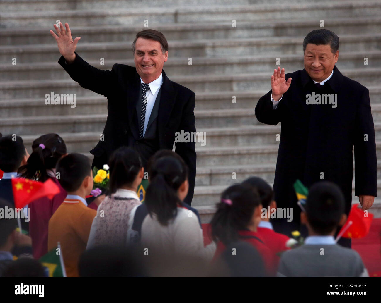 Beijing, China. 25th Oct, 2019. Brazilian President Jair Bolsonaro (R) is escorted by Chinese President Xi Jinping during a welcoming ceremony at the Great Hall of the People in Beijing on Friday, October 25, 2019. Bolsonaro told a forum that China and Brazil 'were born to walk together' and the two governments are 'completely aligned in a way that reaches beyond our commercial and business relationship.' Photo by Stephen Shaver/UPI Credit: UPI/Alamy Live News Stock Photo