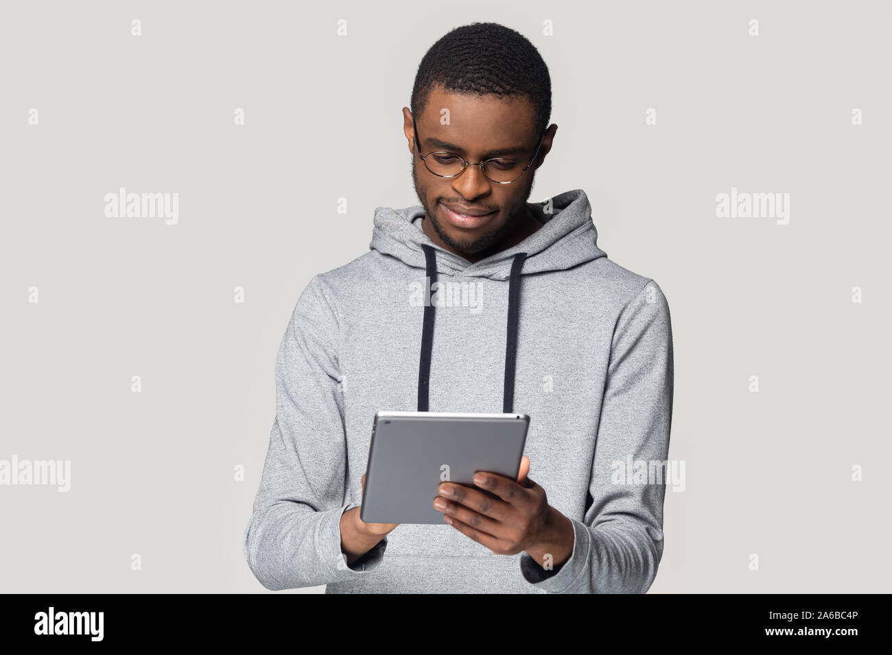 Head shot African American man in glasses using computer tablet Stock Photo