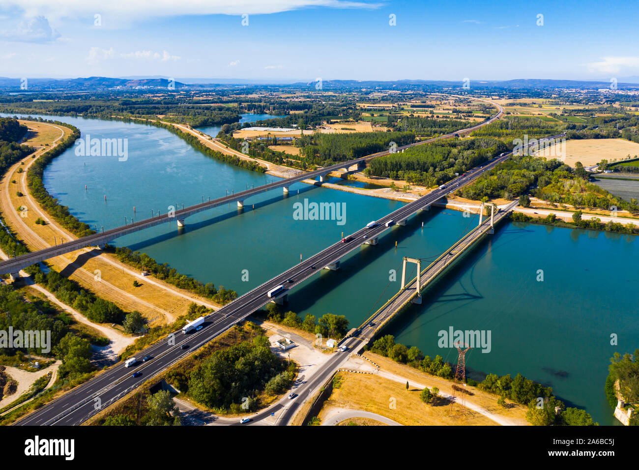 Scenic aerial view of three bridges across Rhone river near small