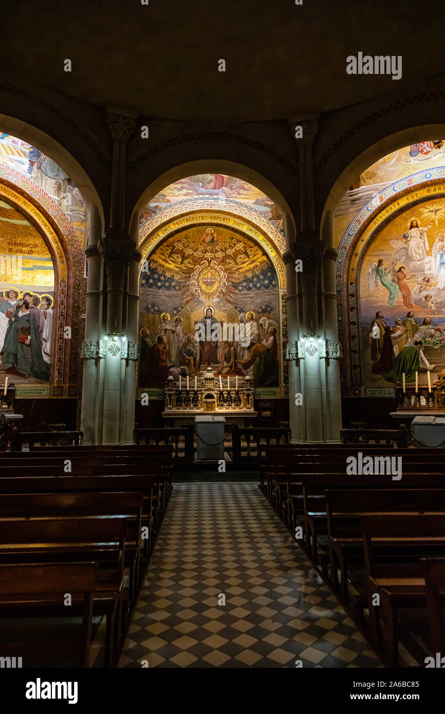 LOURDES, FRANCE - JUNE 15, 2019: Chapel inside the Rosary Basilica in Lourdes displaying Christian murals Stock Photo