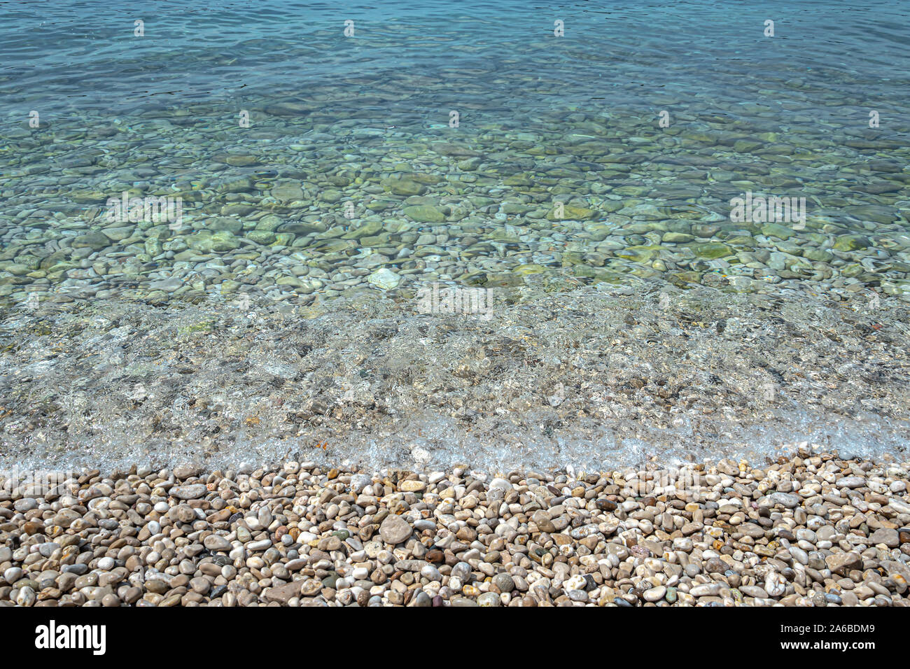 Gravel beach and shallow sea Stock Photo