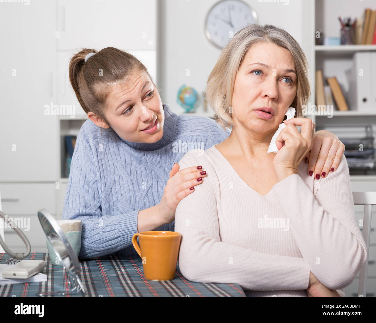 Adult daughter supporting her upset mature mother Stock Photo - Alamy