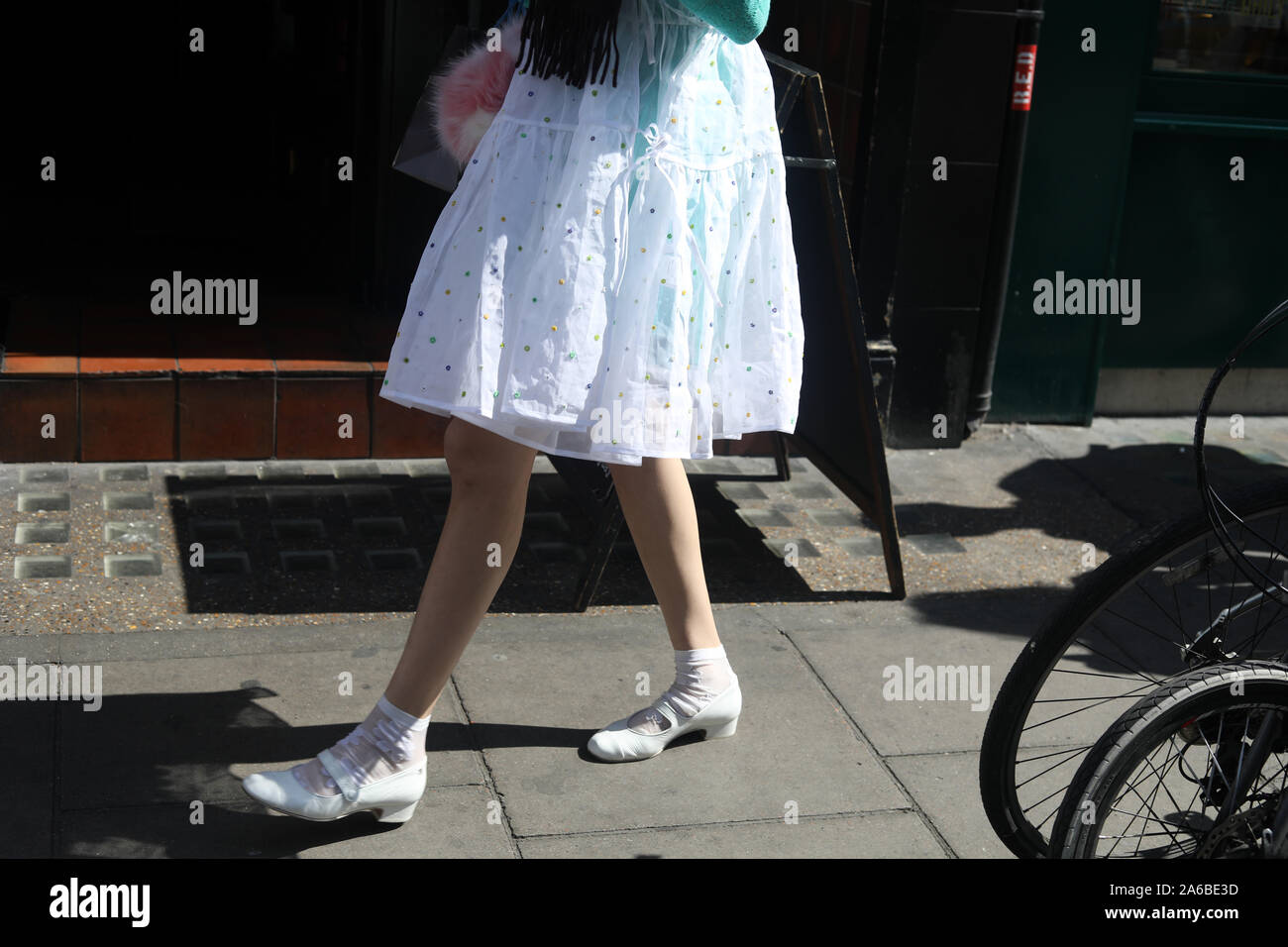 legs white shoes lacy dress Stock Photo