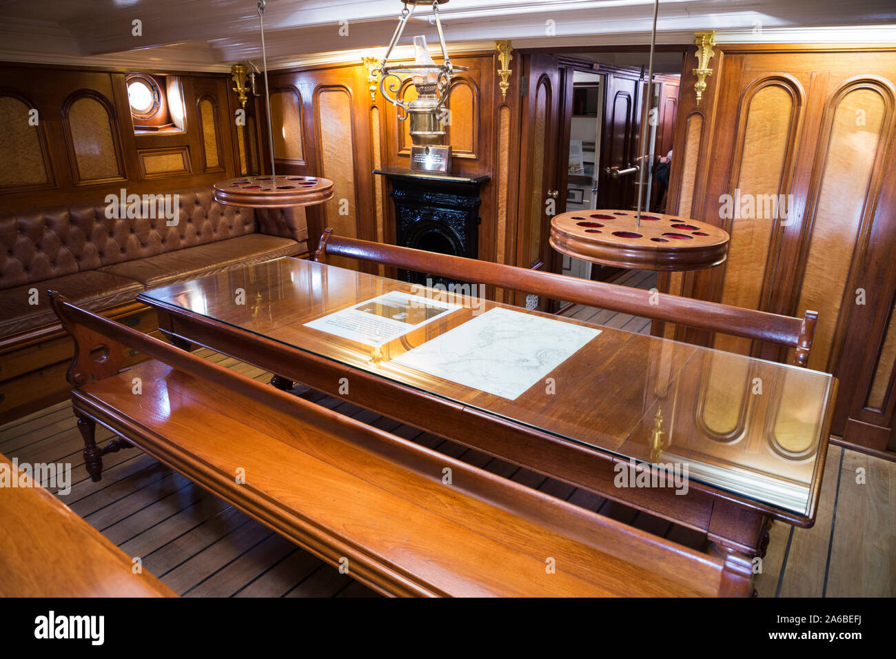 The Saloon on the sailing ship Cutty Sark, for use by the ships Officers. It is appointed with fine polished timbers and wood. Drinks holders are on self-levelling gimbals. (105) Stock Photo