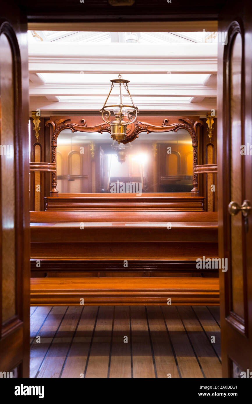 The Saloon on the sailing ship Cutty Sark, for use by the ships Officers. It is appointed with fine polished timbers and wood. Drinks holders are on self-levelling gimbals. (105) Stock Photo