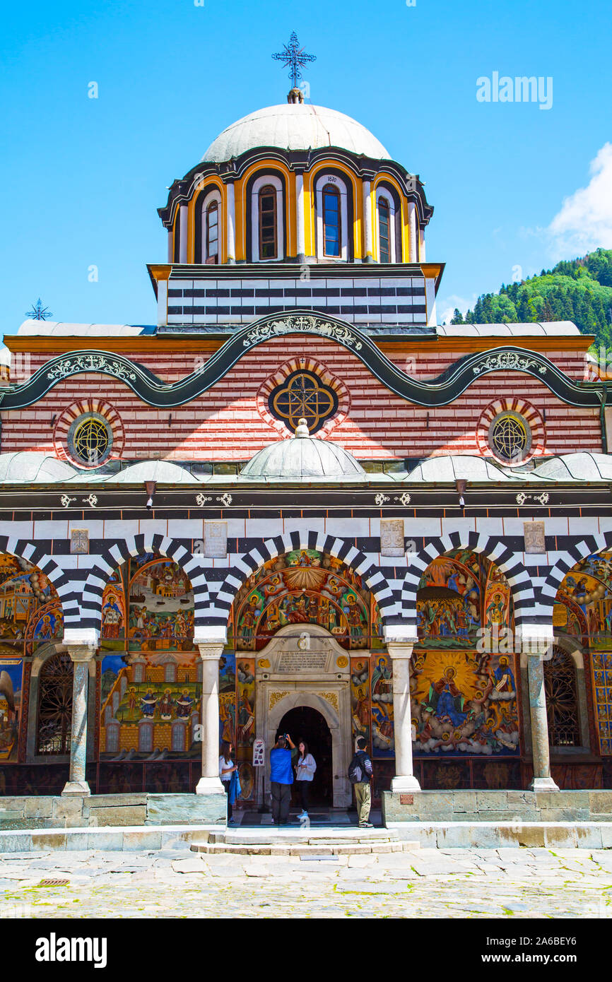 Rila, Bulgaria - June, 25, 2015: Tourists near the church in Unesco World Heritage site Rilsky monastery or Monastery of Saint Ivan of Rila Stock Photo