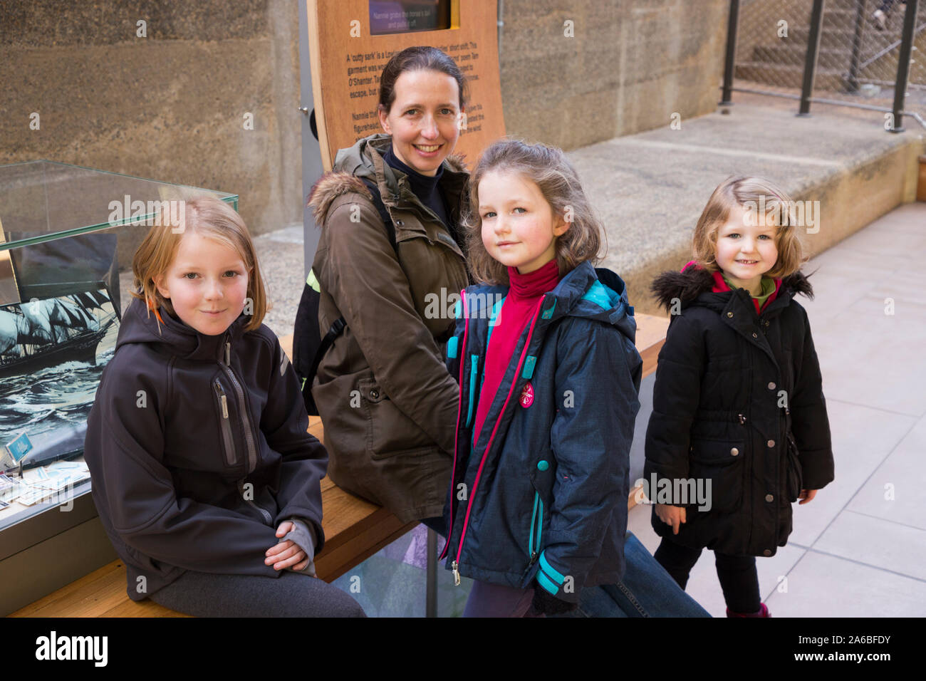 Family of tourists – mother / mum and three happy smiling children ...