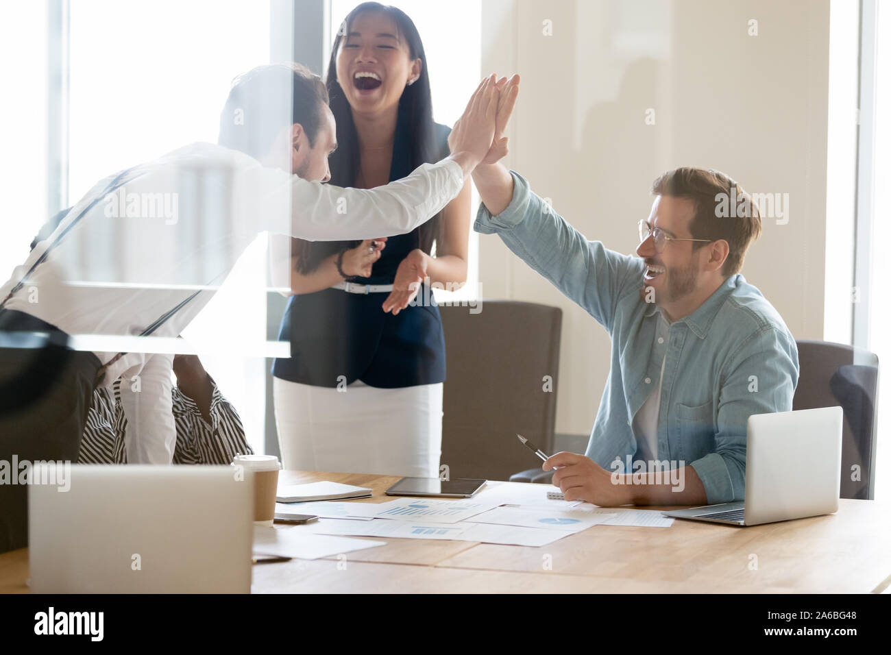Business people giving high five, excited colleagues celebrating ...