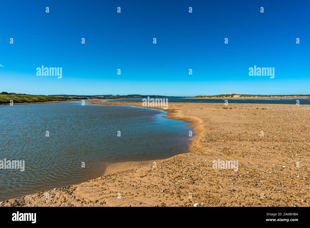 Saltwater pools on Holkham beach looking across the river Burn estuary to Scolt Head Island National Nature Reserve on North Norfolk coast, England UK Stock Photo